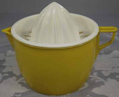 Yellow-orange and white plastic juicer