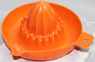 An orange British Plastics Pty. Ltd. Melbourne saucer juicer