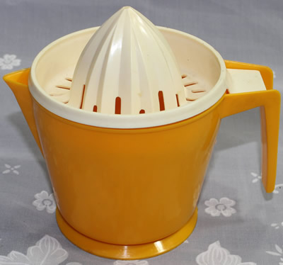 An orange and white HOSTESS brand 2 piece juicer