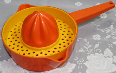 An orange and yellow Decor plastic pot shape juicer