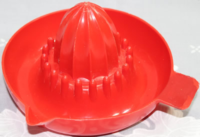 A dark red British Plastics Pty. Ltd. saucer juicer