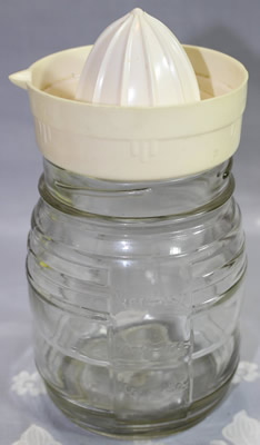 Cream colour plastic juicer on glass jar