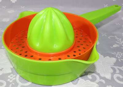 A lime green and red Decor plastic pot shape juicer