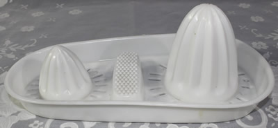 A white plastic twin dome strainer juicer