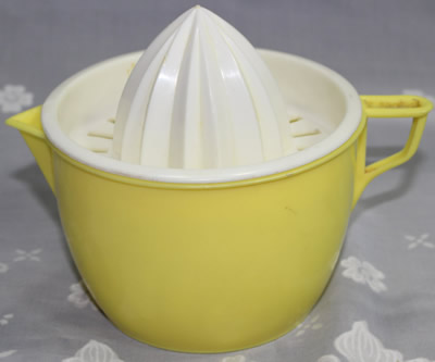 Yellow plastic jug with white top juicer