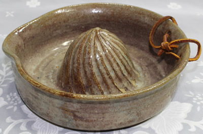 Greys and brown pottery bowl juicer with leather loop